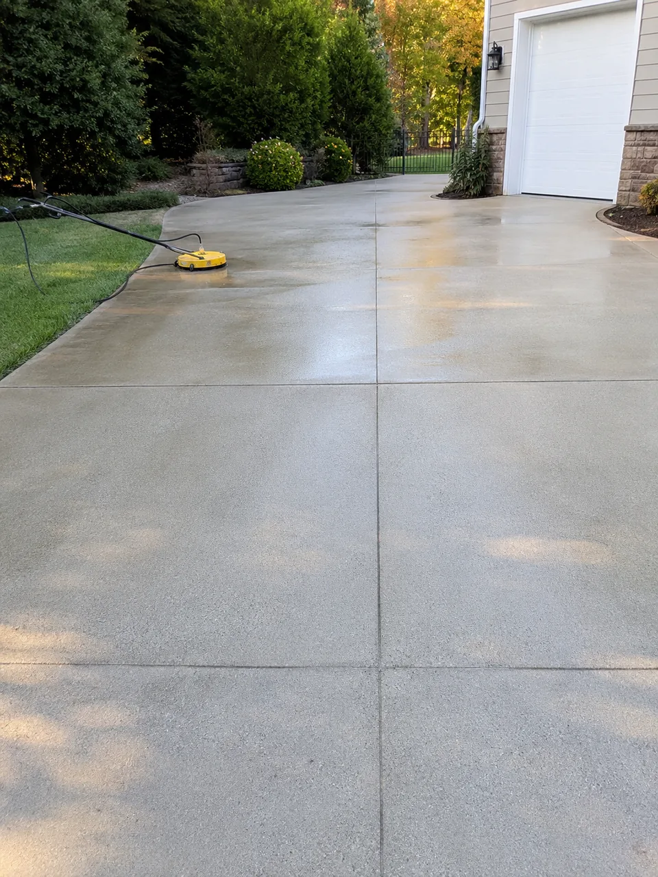 Technician pressure washing a walkway at a Merrillville - IN property to remove embedded grime